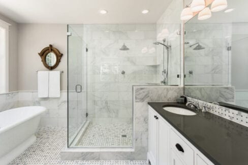 White Marble Tile with Frameless Glass Shower | Historic Home Restoration and Design-Build Renovation